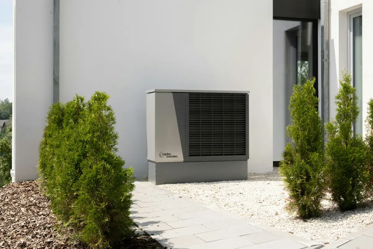 Cold-climate heat pump outdoor unit mounted on Tampa home exterior
